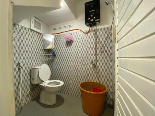 a small bathroom with a toilet and a shower at Villa Murah Malang in Malang