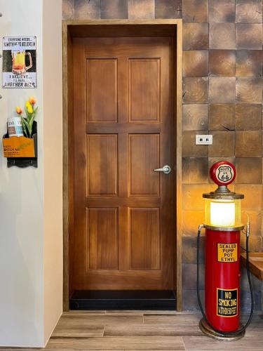 a fire hydrant sitting in front of a door at Annong Image Vacation Home in Sanxing