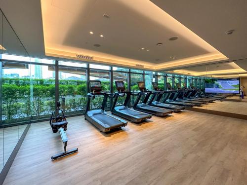 a gym with a row of treadmills in a building at Address Opera Residences Burj Khalifa View in Dubai