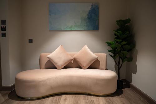 a couch with two pillows in a living room at Moose Hotel Nimman in Chiang Mai