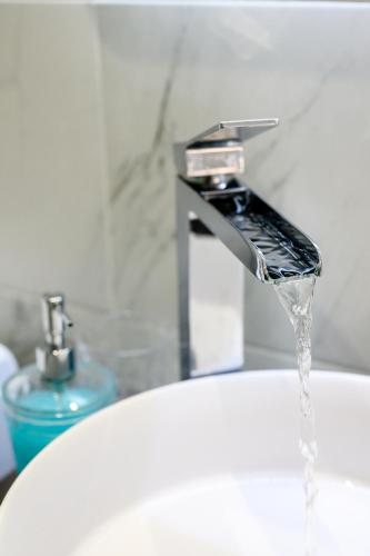 a sink with water coming out of a faucet at Marillia's elegance residence in Mesaria