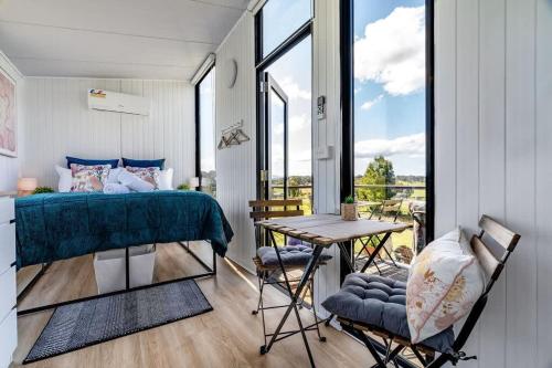 a bedroom with a bed and a table and chairs at Gold Fields 