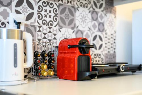 a red toaster sitting on top of a counter at Marillia's elegance residence in Mesaria