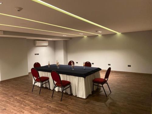a conference room with a table and red chairs at Holiday Inn Express Morelia by IHG in Morelia