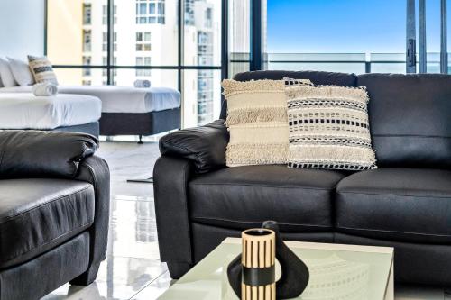 a living room with a couch and a table at Circle on Cavill - QStay in Gold Coast