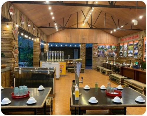 a restaurant with tables and chairs in a room at Ha Giang Eco Bungalow in Ha Giang