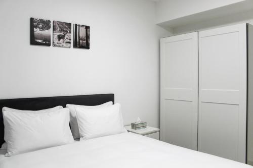 a bedroom with a white bed and a white cabinet at Luxury Suite Apartment #45 By Hashdera Eilat in Eilat