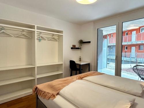 a bedroom with a bed and a desk and a window at sHome Apartments Graz - Self-Check-in & free parking in Graz