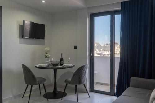a living room with a table and chairs and a window at Aegean Stars in Rhodes Town