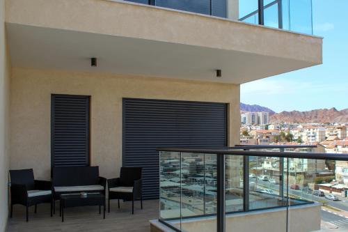 a balcony with black blinds on a building at Luxury Suite Apartment #45 By Hashdera Eilat in Eilat