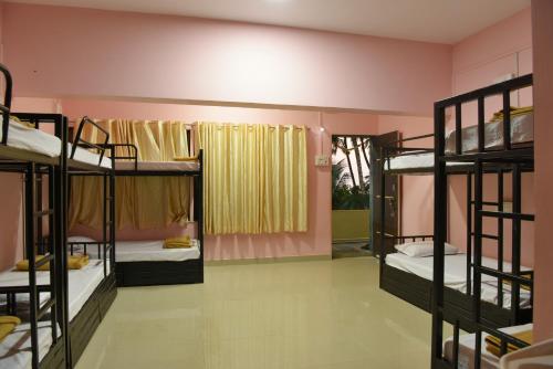 a room with several bunk beds in it at Divers Nest Hostel And Homestays in Malvan