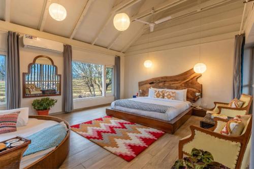 a bedroom with a bed and a large window at Seclude Palampur in Pālampur