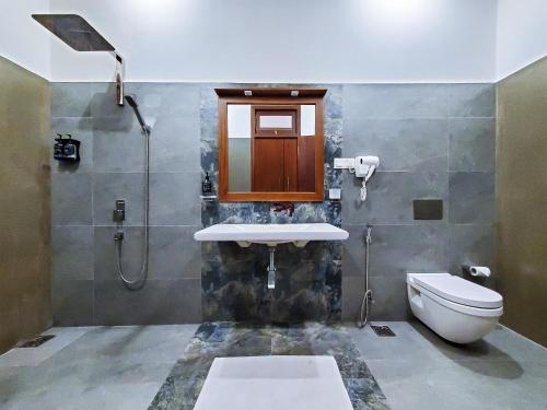 a bathroom with a sink and a toilet at Villa Ema in Galle