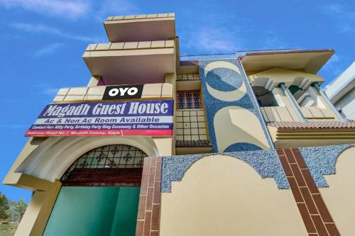 a building with a sign on the side of it at OYO Flagship Magadh Guest House in Gaya