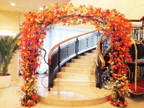 an entrance to a spiral staircase with an arch of flowers at Hotel Bellclassic Tokyo in Tokyo
