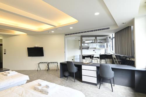a hotel room with a kitchen and a living room at Chill Place ll in Zhudong