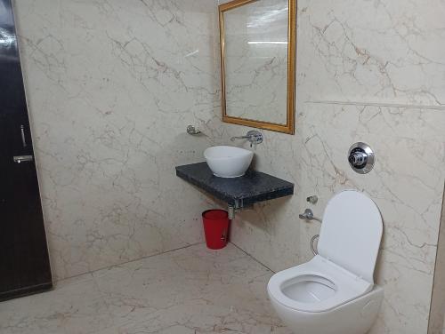 a bathroom with a white toilet and a sink at Hotel Airlines in Amritsar