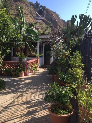 a courtyard with potted plants and a house at Holiday Home Gionny & Mary in Taormina
