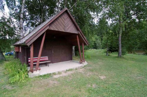 a small shed with a bench in a park at Autokemp Panistávka Žirovnice in Žirovnice