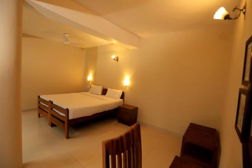 a bedroom with a bed in a room at Hideaway By Aahma in Rāmnagar