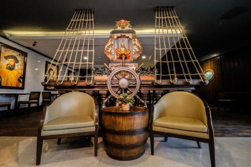 a bar with two chairs and a table with a barrel at Cebu Quincentennial Hotel in Cebu City