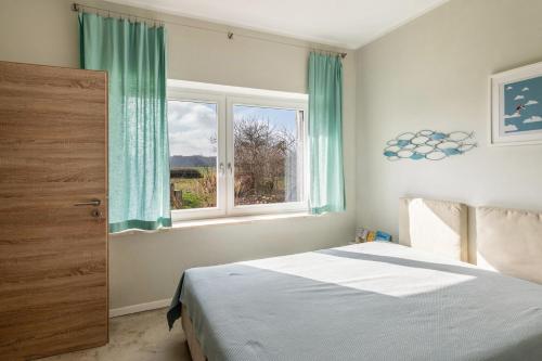 a bedroom with a bed and a window at Hof Himmelgrün in Saal