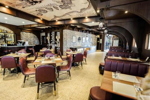 a restaurant with wooden tables and chairs and a bar at Cebu Quincentennial Hotel in Cebu City