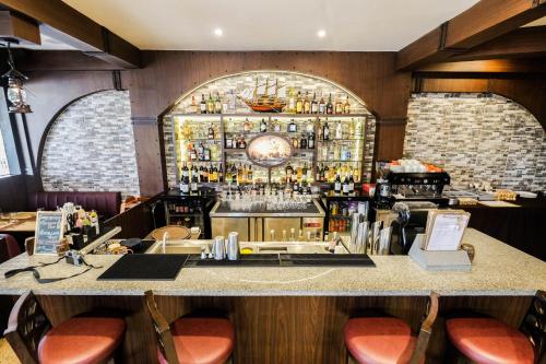 a bar at a restaurant with red stools at Cebu Quincentennial Hotel in Cebu City
