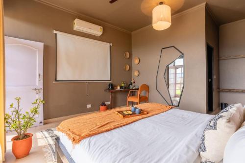 a bedroom with a large bed with a mirror at Seclude Palampur in Pālampur