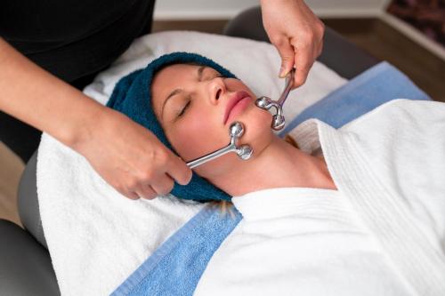 a woman laying in a hospital bed with a stethoscope at Four Points by Sheraton Bansko in Bansko