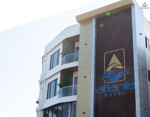 a hotel with a sign on the side of a building at Hotel Atlanta - A Seaview Hotel in Port Blair