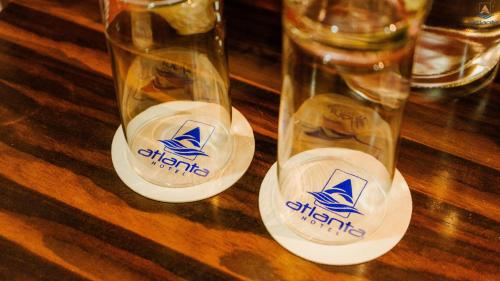a pair of glasses sitting on a wooden table at Hotel Atlanta - A Seaview Hotel in Port Blair