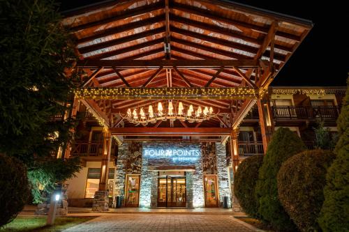 a building with a sign on the front of it at Four Points by Sheraton Bansko in Bansko