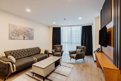 a living room with a couch and two chairs at Best Western Plus Batumi in Batumi