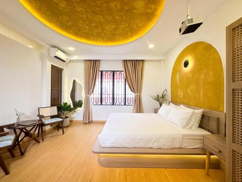 a bedroom with a bed with a large yellow orb on the ceiling at AIRIE LIVING in Ho Chi Minh City