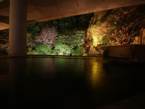 a painting of trees on a wall under a bridge at Ryumontei Chiba Ryokan in Ōyu