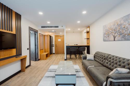 a living room with a couch and a tv at Best Western Plus Batumi in Batumi