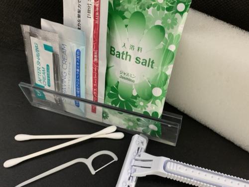 a group of books and a toothbrush and toothpaste at Hotel Alpha-One Marugame in Marugame