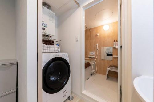 a laundry room with a washing machine in a bathroom at SECLUSION 千歳MS102 in Chitose