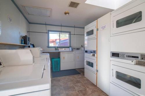 a kitchen with white appliances and a window at Moab RV Resort Glamping Tipi OKTP-51 in Moab