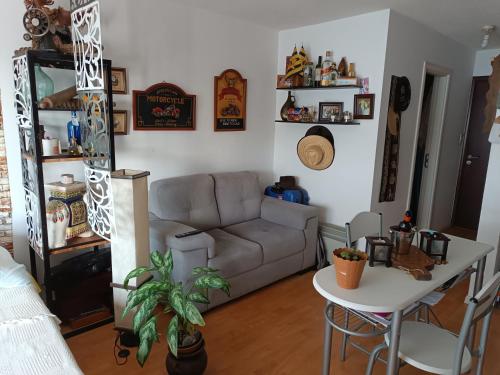a living room with a couch and a table at Monoambiente equipado en Pocitos cerca xoo y rambla in Montevideo