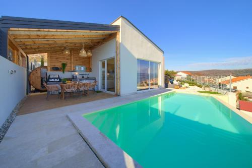 a house with a swimming pool next to a house at Villa Bella Vista in Vrbnik