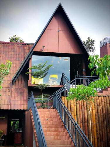 a building with a staircase leading up to a window at Kap Korome Village Resort in Koroth