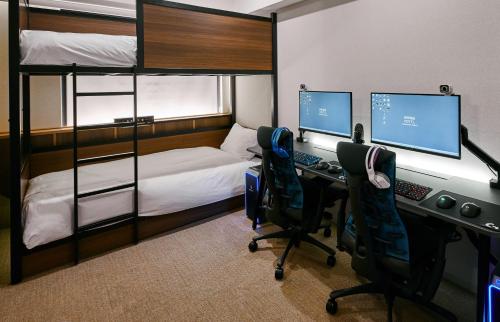 a bedroom with a desk and two bunk beds at NOHGA HOTEL AKIHABARA TOKYO in Tokyo