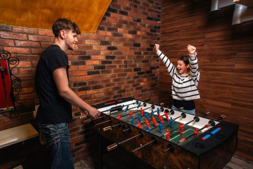 a man and a girl playing with a foosball at BeFree Hostel - Self-Service in Vienna