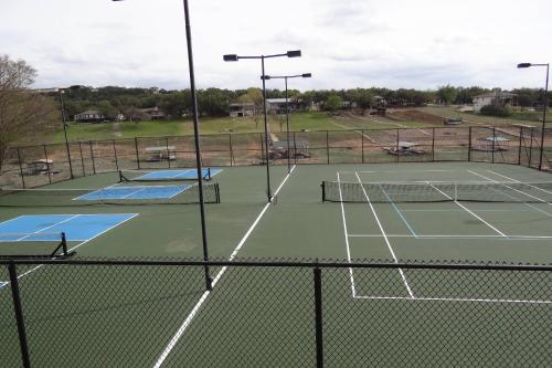 a tennis court with two tennis courts at Vela Villa in Lago Vista