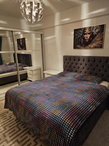a bedroom with a large bed and two mirrors at Belle maison ! in Brussels