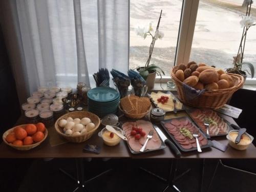 a table with a bunch of food on it at Villa Stuga in Hammarstrand