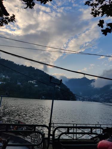a view of a large body of water with benches at Cedar Lodge By Aahma in Rāmgarh