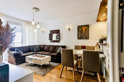 een woonkamer met een bank en een tafel bij AP PR11 in one of the most luxury building in Omis in Omiš